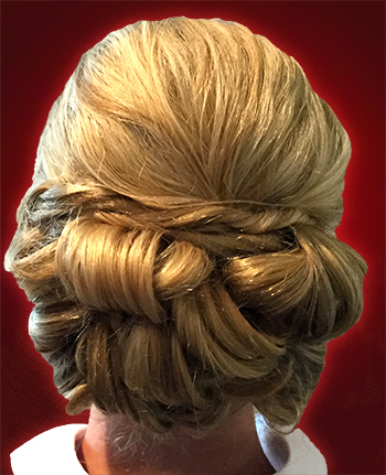 Close up picture of bonde girl's hair styled in an up do.